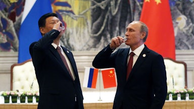 Putin and Xi toast with vodka