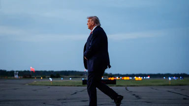 Donald Trump walks on an airport tarmac