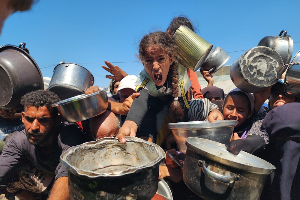 Palestinians struggling with hunger crowd around as a charity distributes food in the Al-Mawasi area of Khan Yunis, Gaza amid ongoing Israeli restrictions blocking humanitarian aid from reaching Gaza, on July 24, 2025.