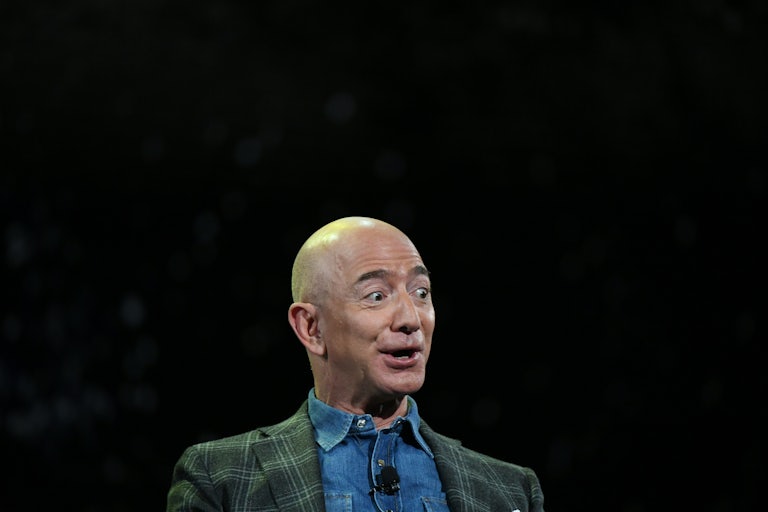 Jeff Bezos, against a black backdrop, looks surprised and excited 