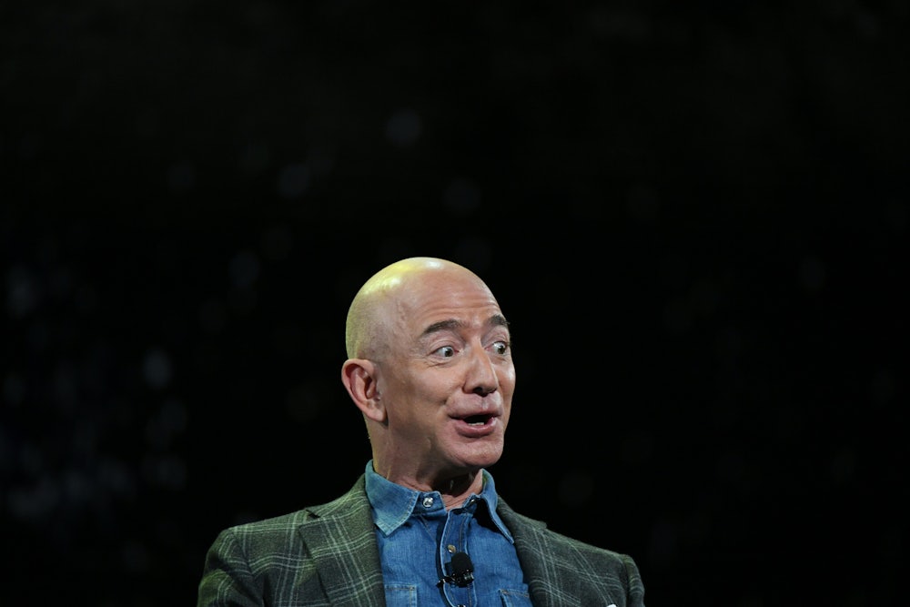 Jeff Bezos, against a black backdrop, looks surprised and excited