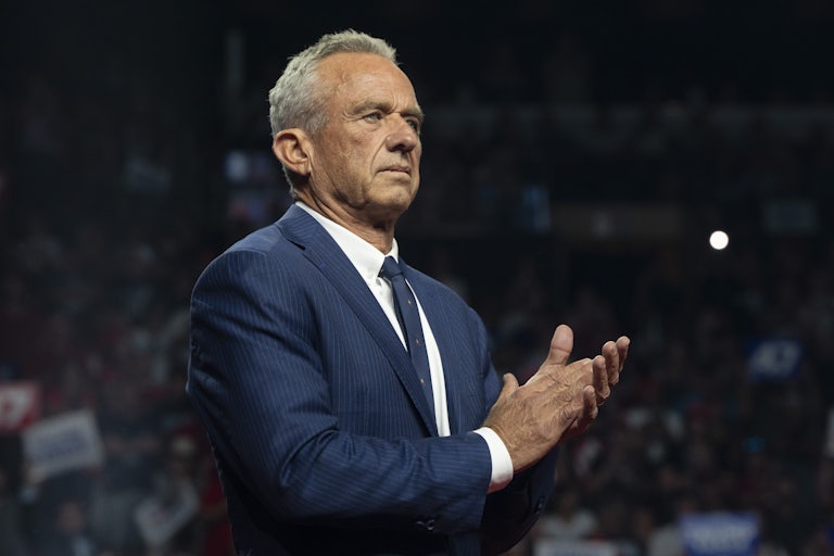 Robert F. Kennedy Jr. claps while onstage at a Donald Trump rally