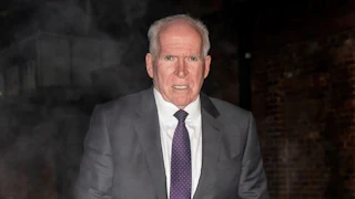 Former CIA Director John Brennan walks