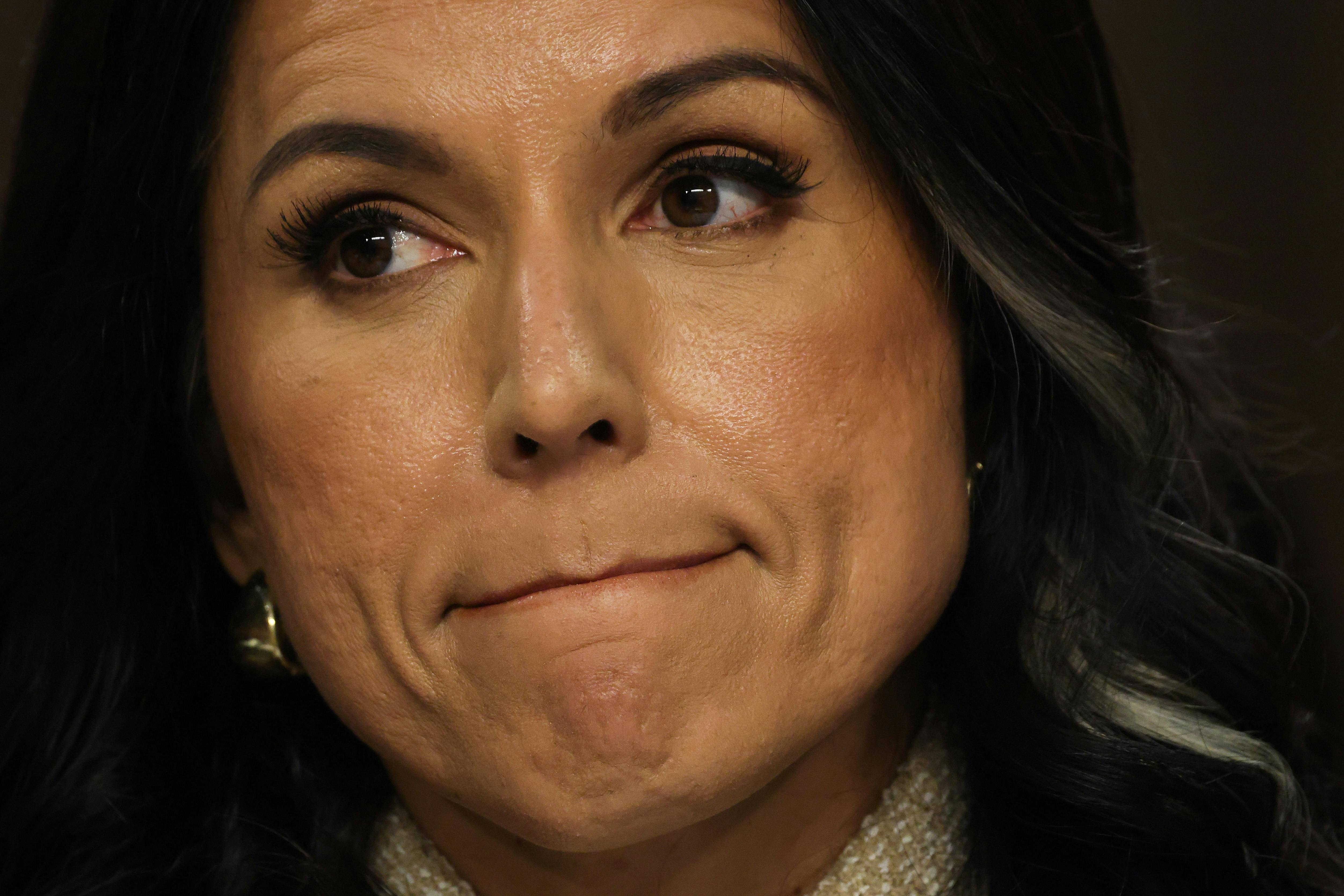 DNI Tulsi Gabbard presses her lips together as she testifies in Congress.