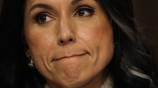 DNI Tulsi Gabbard presses her lips together as she testifies in Congress.