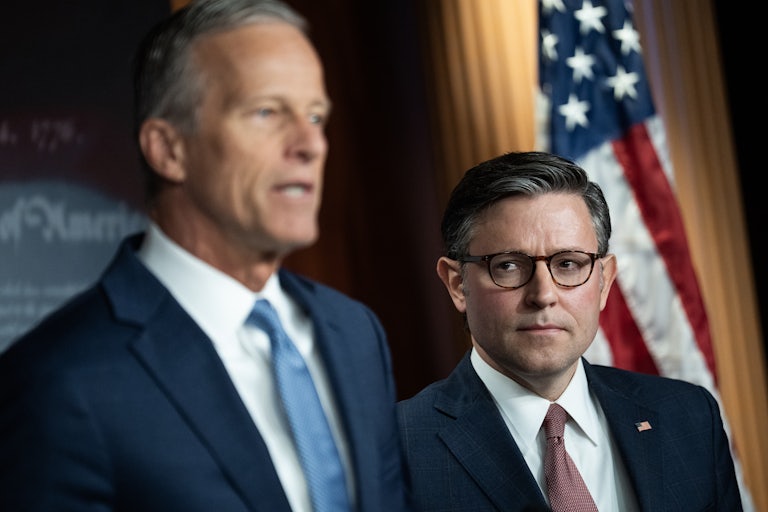 House Speaker Mike Johnson looks at Senate Majority Leader John Thune, who speaks
