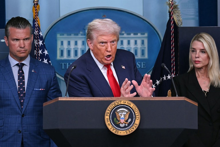 Donald Trump angrily talks about crime while flanked by Pete Hegseth and Karoline Leavitt