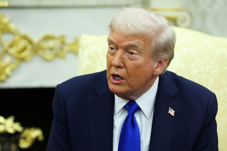 Donald Trump speaks while sitting in the Oval Office