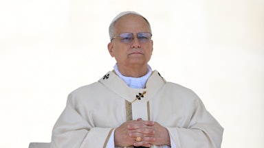 Pope Leo crosses his hands across his chest.