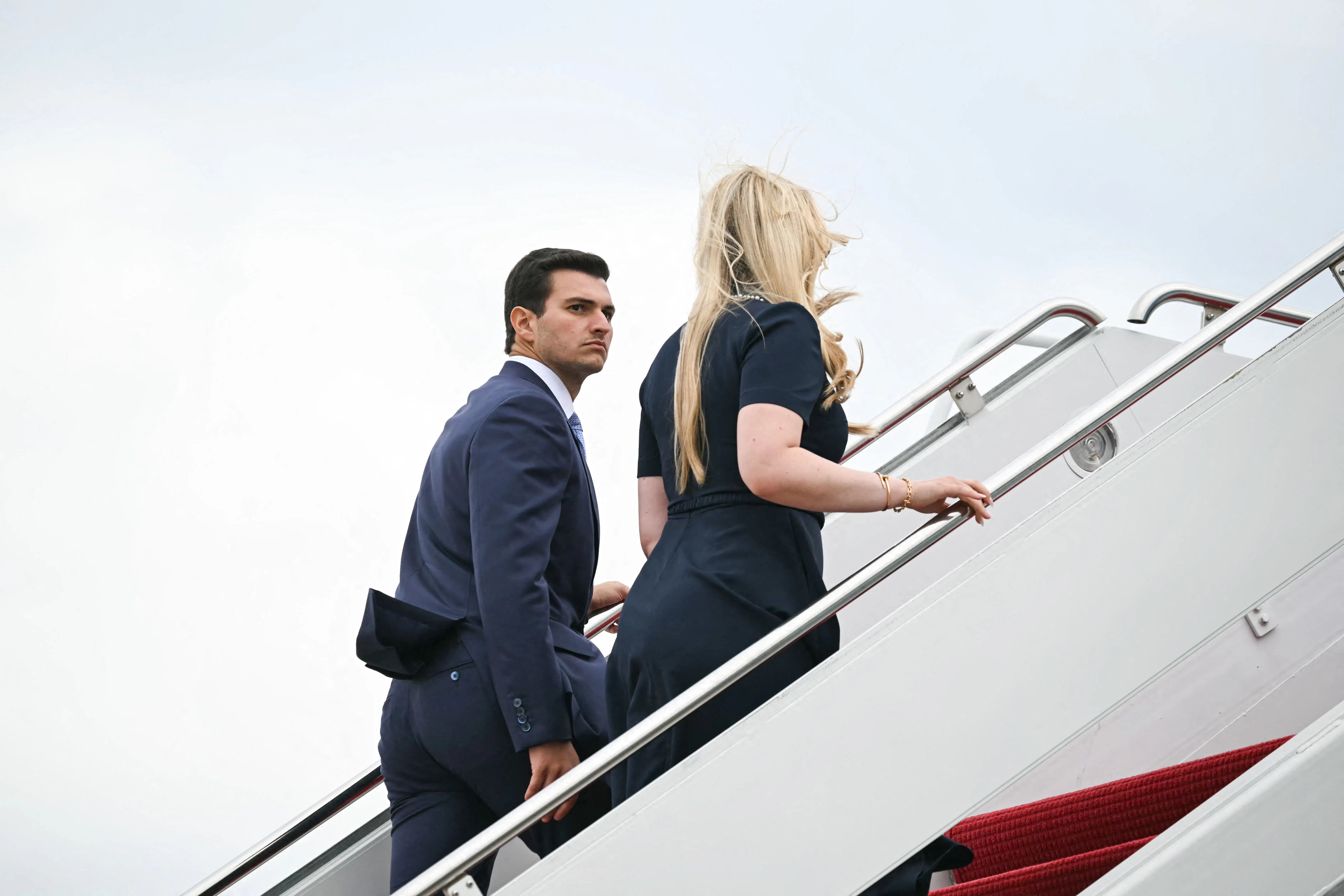 Tiffany Trump and her husband Michael Boulos board a plane