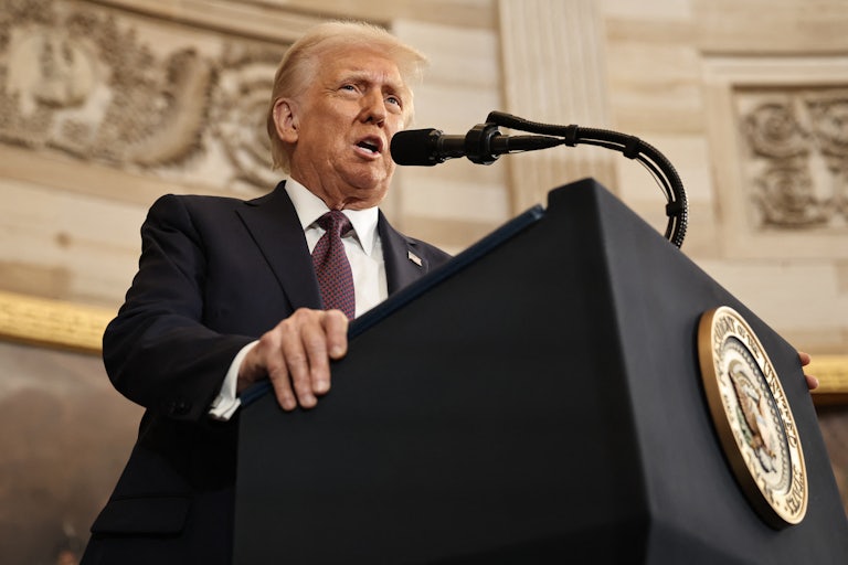Trump speaks while standing at a lectern.