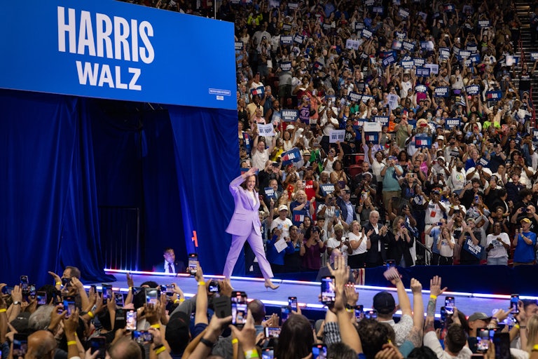 Kamala Harris walks out at a rally and waves to the crowd