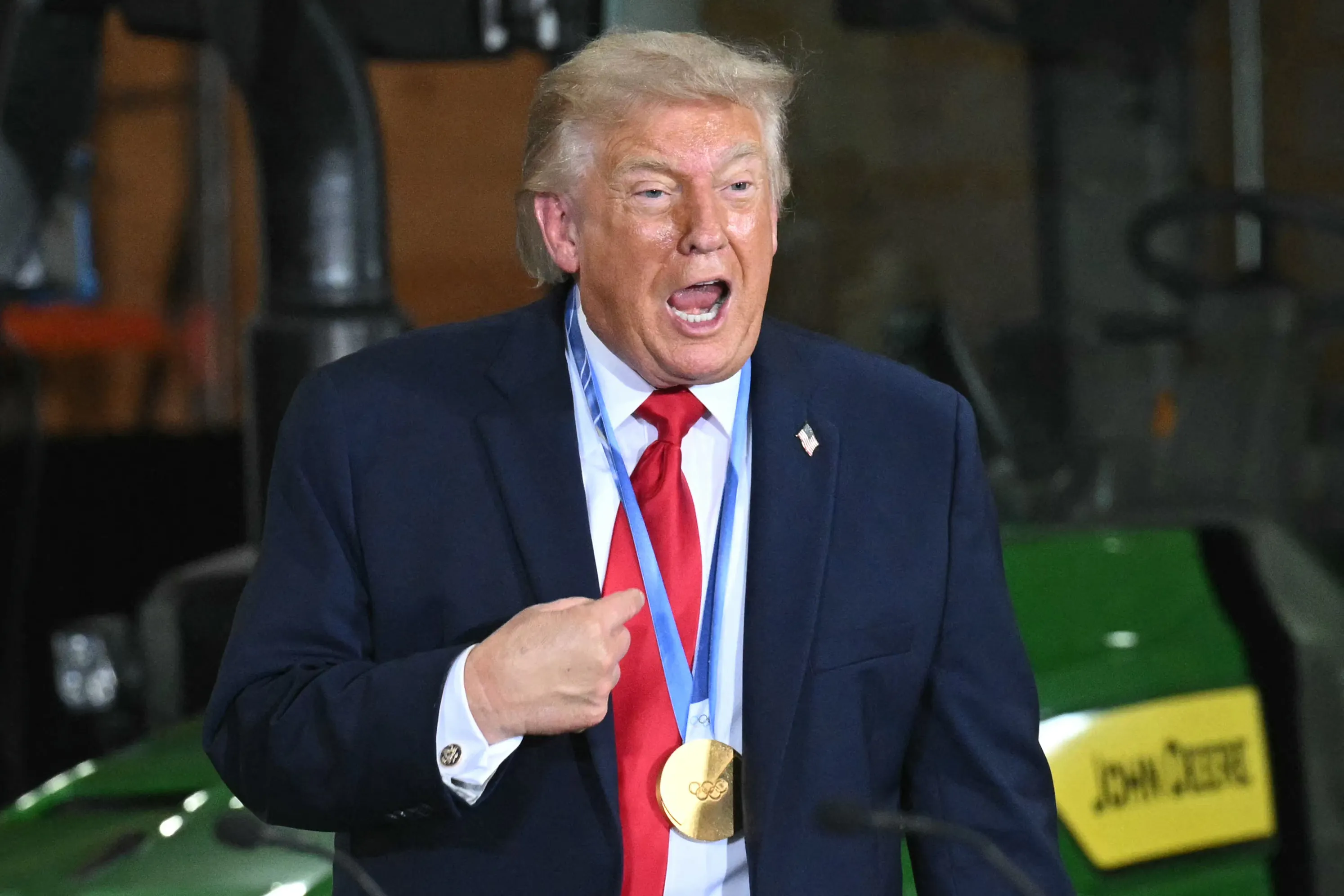 Donald Trump speaks vehemently while wearing a medal