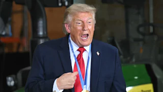 Donald Trump speaks vehemently while wearing a medal