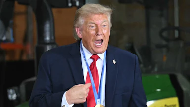 Donald Trump speaks vehemently while wearing a medal