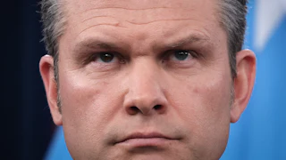 Defense Secretary Pete Hegseth frowns during a press conference