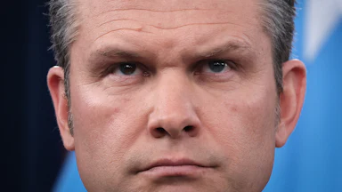 Defense Secretary Pete Hegseth frowns during a press conference