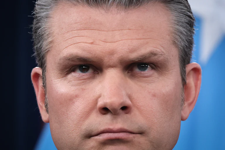 Defense Secretary Pete Hegseth frowns during a press conference