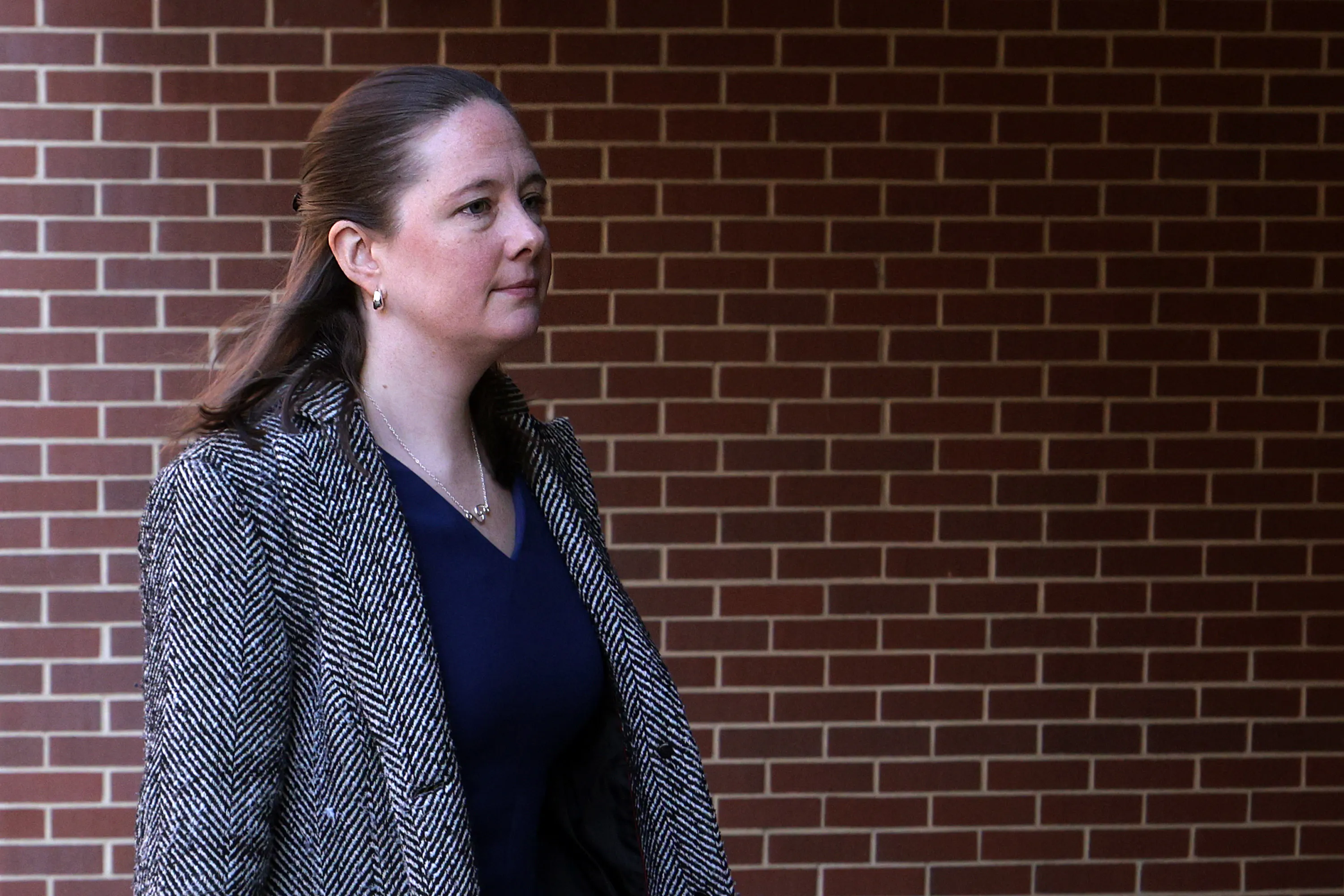 Maurene Comey walks outside a courthouse
