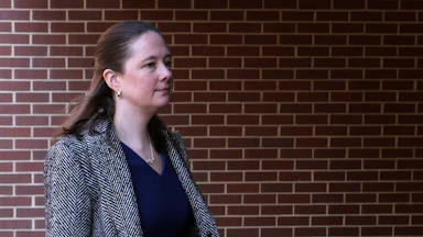 Maurene Comey walks outside a courthouse