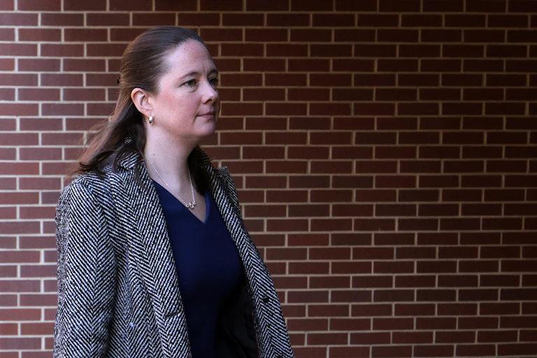 Maurene Comey walks outside a courthouse
