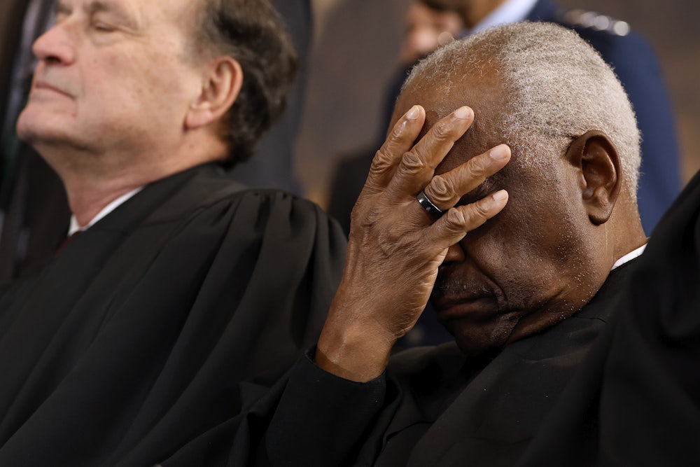 Supreme Court Associate Justice Clarence Thomas covers his face as he waits for the opportunity to leave the stage at the conclusion of Trump’s second inauguration ceremonies.