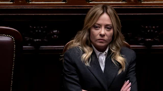 Italian Prime Minister Giorgia Meloni crosses her arms