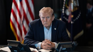 Donald J. Trump sits at a table monitoring military operations during Operation Epic Fury against Iran