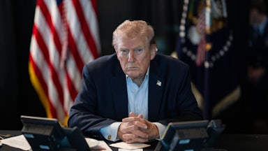 Donald J. Trump sits at a table monitoring military operations during Operation Epic Fury against Iran