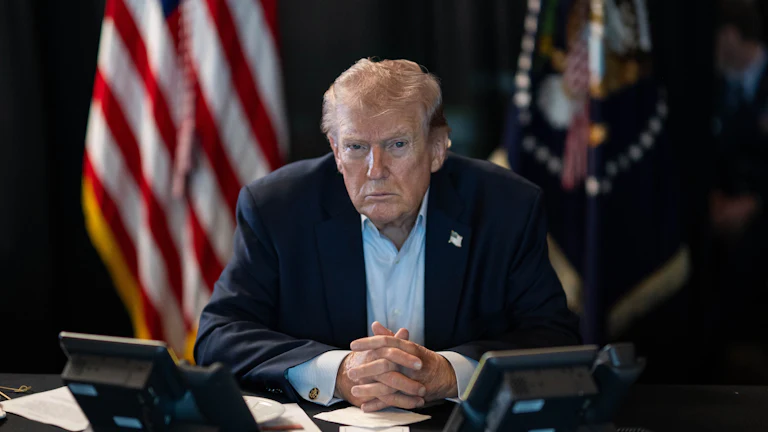 Donald J. Trump sits at a table monitoring military operations during Operation Epic Fury against Iran