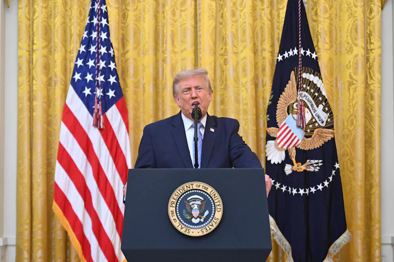 Donald Trump at the podium next to the U.S. flag