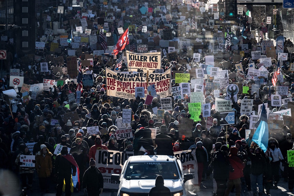 This image shows masses of protesters holding signs protesting ICE.