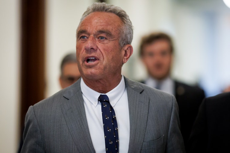 Robert F. Kennedy Jr. speaks while walking in the Capitol