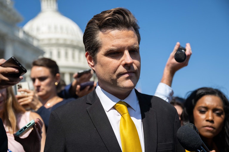 Matt Gaetz outside the Capitol. Women reporters surround him.