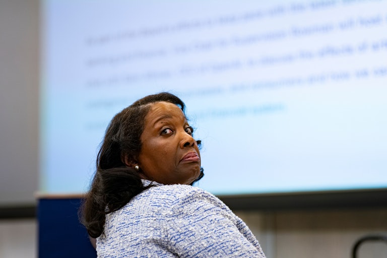 Ousted Fed Governor Lisa Cook looks over her shoulder while seated
