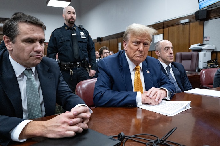 Donald Trump sits between his lawyers Todd Blanche and Emil Bove