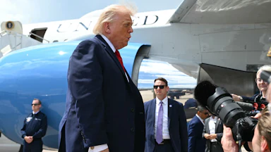 Donald Trump speaks to reporters after exiting Air Force One
