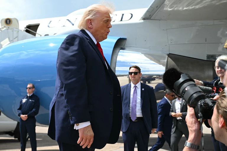 Donald Trump speaks to reporters after exiting Air Force One