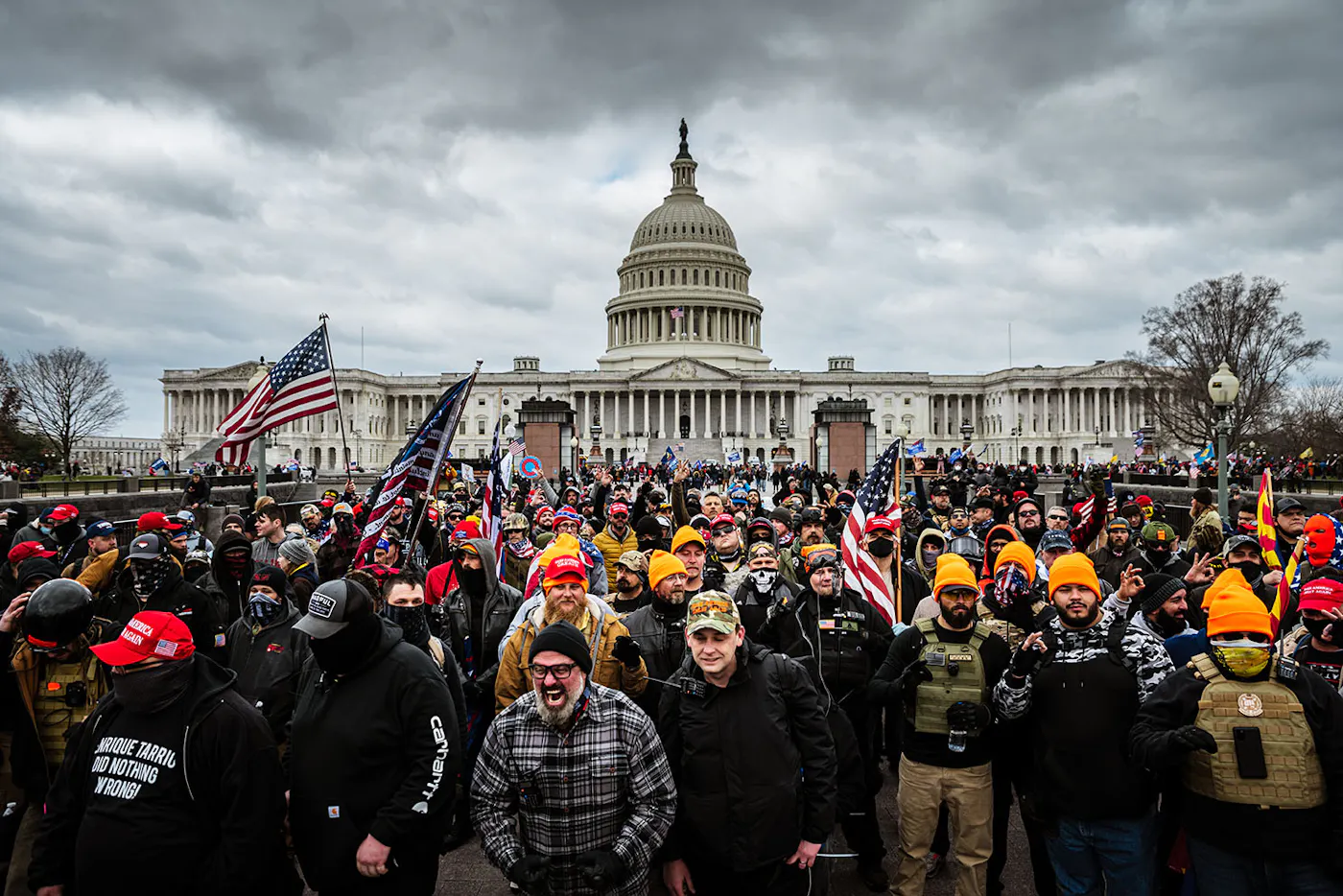 A large crowd of MAGA rioters on the grounds of the U.S. Capitol building under an overcast sky on January 6, 2021