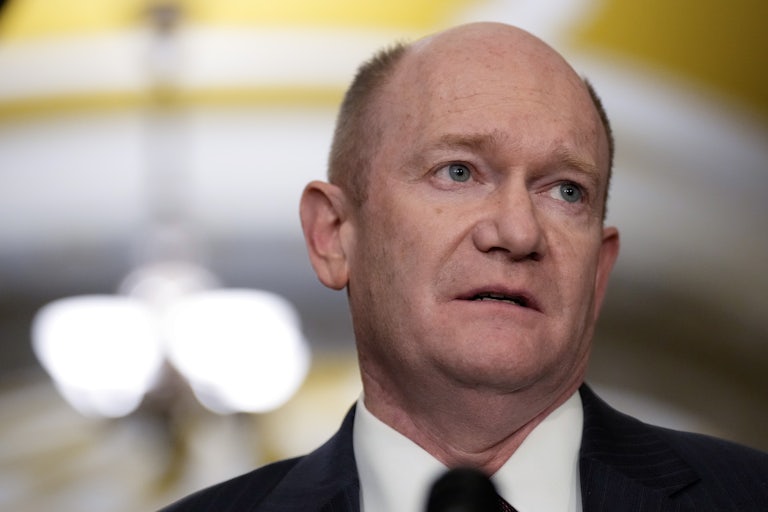 Chris Coons looks to the side