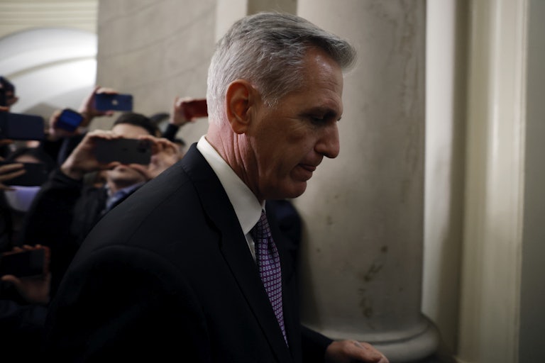 Representative Kevin McCarthy looks down and walks away from reporters