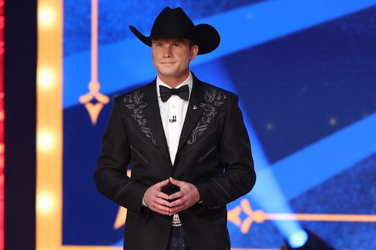 Pete Hegseth stands on stage