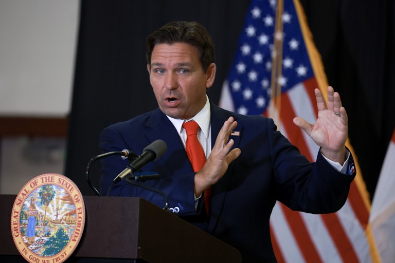 Ron DeSantis gestures while speaking at a podium