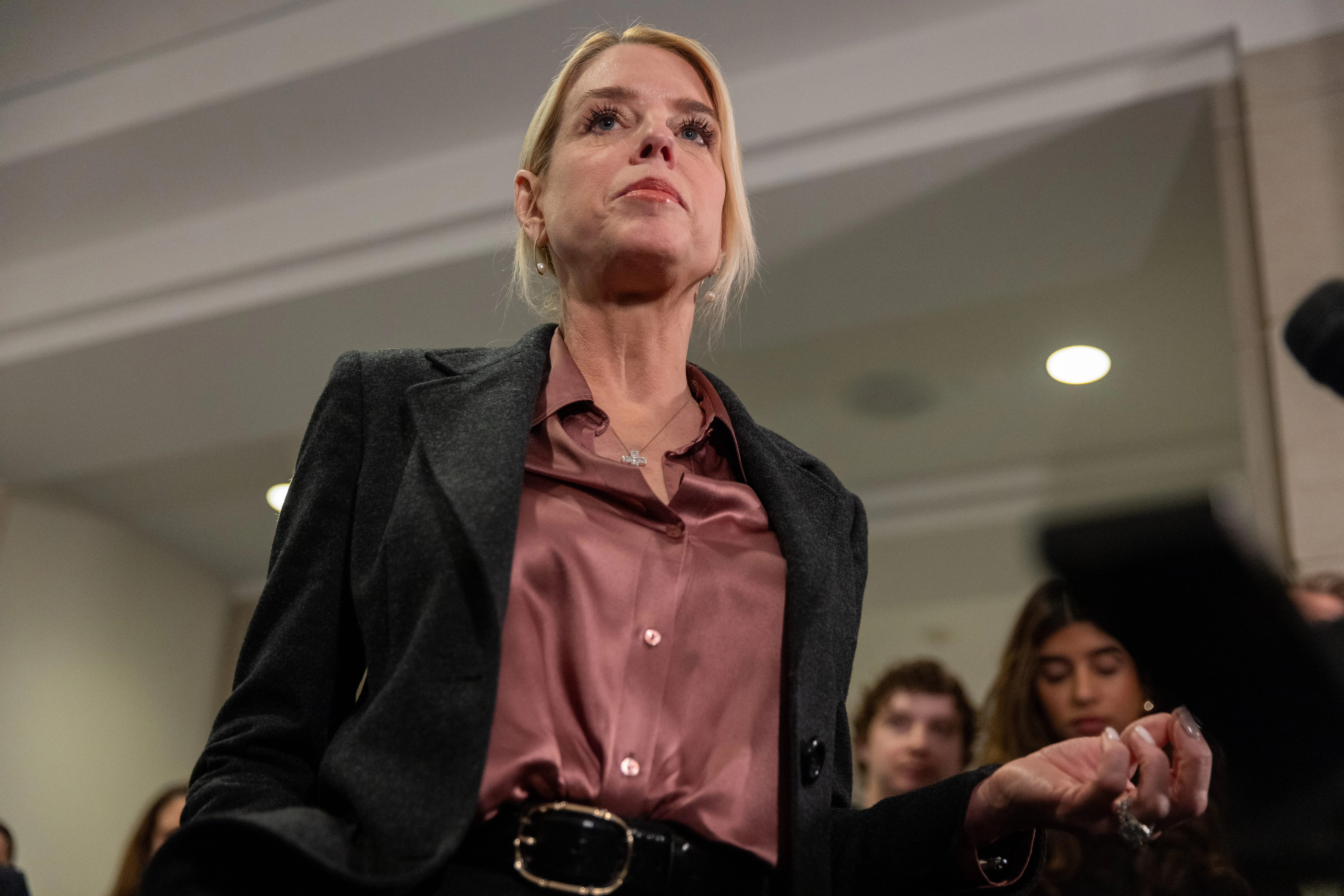Ex-Attorney General Pam Bondi stands in front of reporters in the Capitol