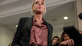 Ex-Attorney General Pam Bondi stands in front of reporters in the Capitol