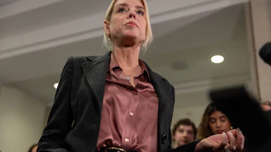 Ex-Attorney General Pam Bondi stands in front of reporters in the Capitol