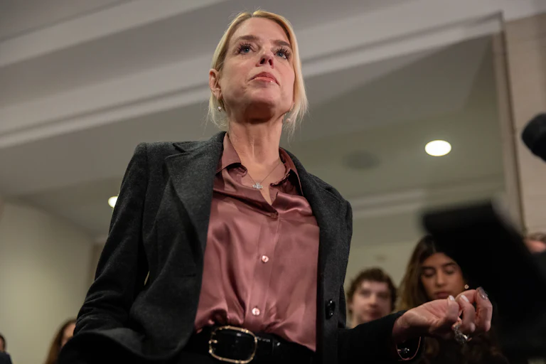 Ex-Attorney General Pam Bondi stands in front of reporters in the Capitol