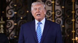Donald Trump speaks in front of an ornate door.