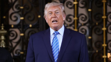 Donald Trump speaks in front of an ornate door.