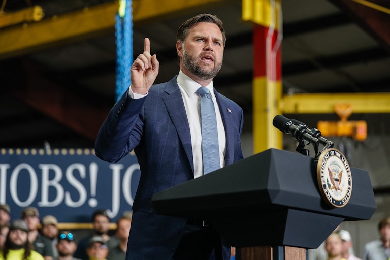 Vice President JD Vance raises his finger while speaking at a podium during an event